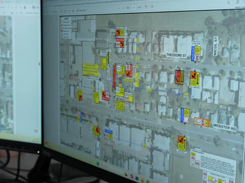 Traffic management design plan displayed on monitor showing roadwork signage and traffic control layout
